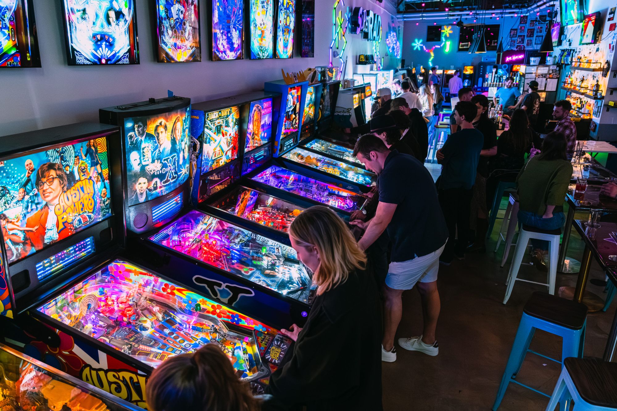 Guests playing pinball at Raleigh's best barcade