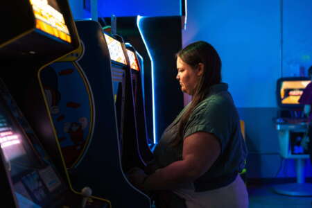 Guests playing classic arcade games at a Raleigh barcade