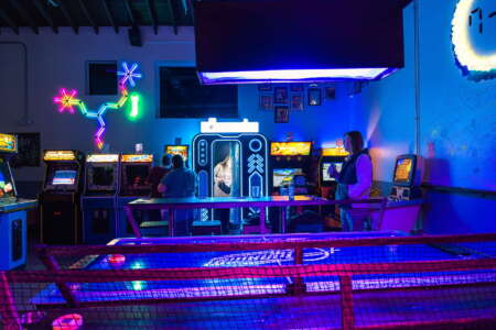 Crowd enjoying a themed event at a Raleigh arcade bar